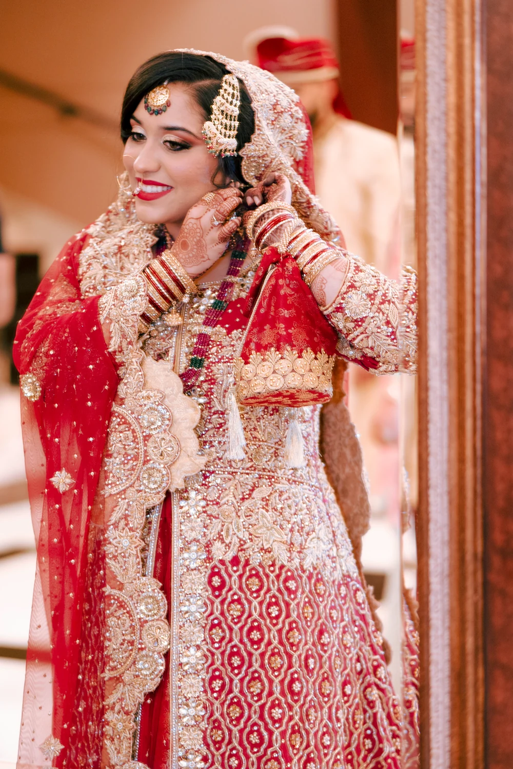 A bride adjusting her earring before the wedding